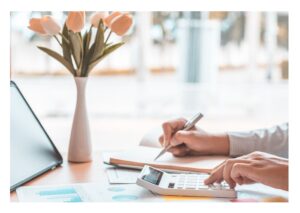 A small business owner  calculating new pricing.