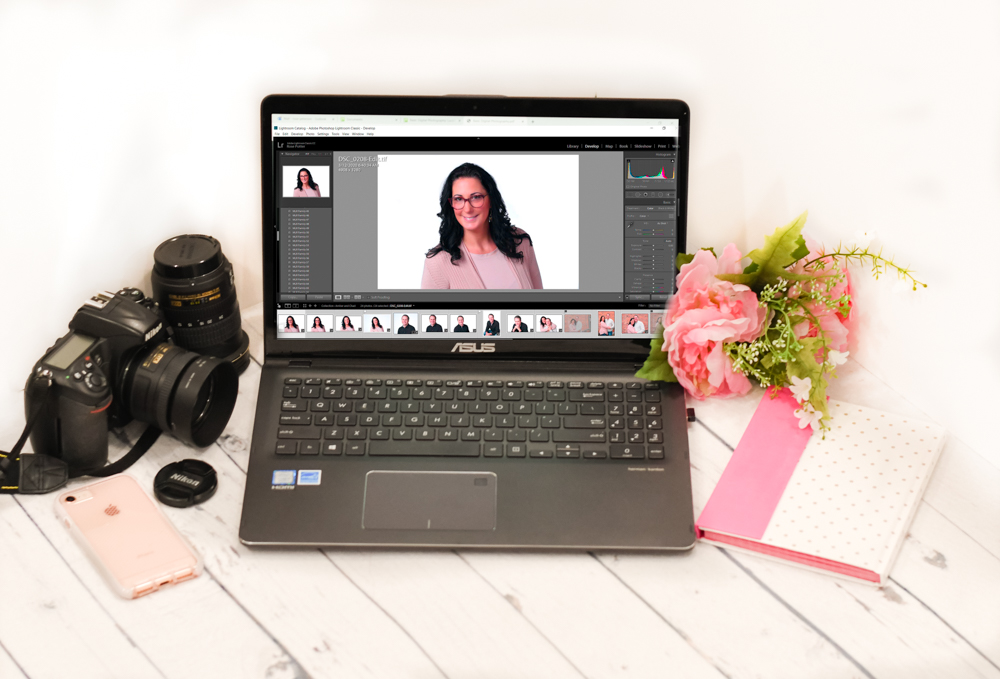 Photo of a computer with editing software and a camera.